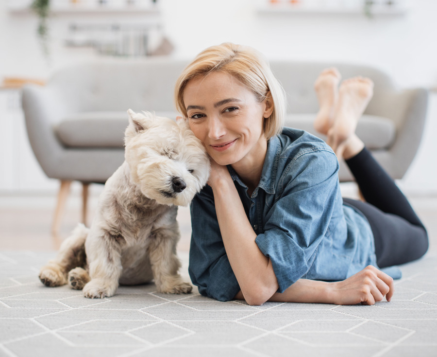 femme souriante et son chien vous regardant